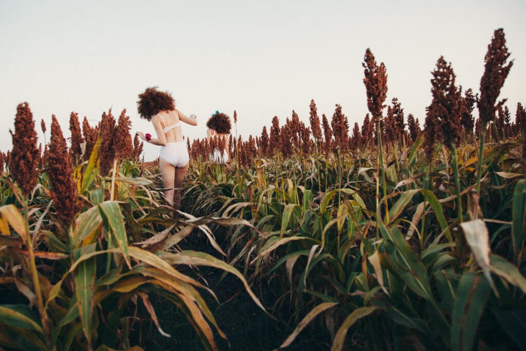 A woman running through the grass in a field.